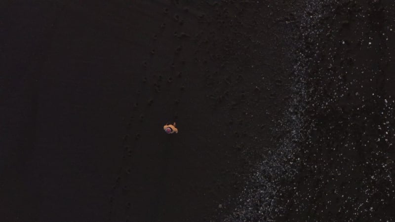 A Photographer on the Black Sand Beach in Iceland at Sunset