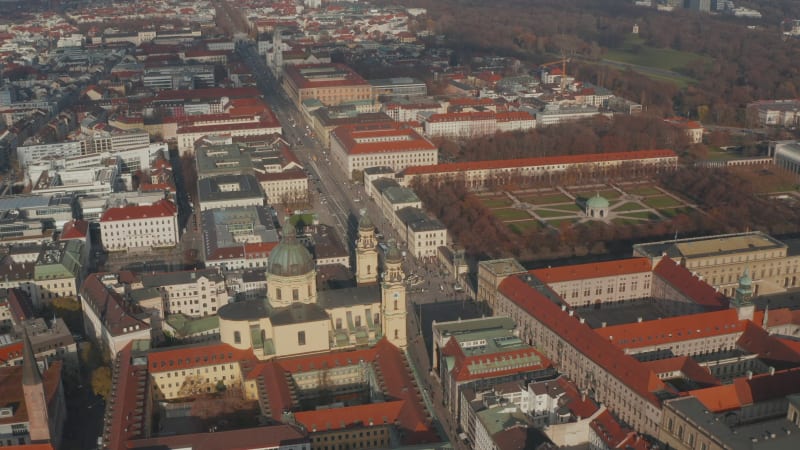 Wide View above Court Garden in Munich, Germany and City streets with Traffic in Winter, Daylight Aerial forwards slow tilt down