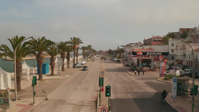 Aerial drone view of Avenida dos Descobrimentos street in historical city of Lagos, Portugal, dolly in, sunny day