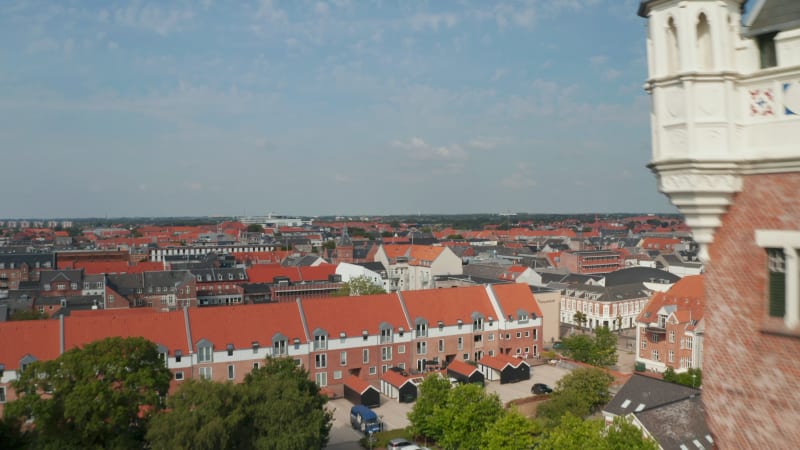 Aerial view flight nearby the Water Tower, historical monument of Esbjerg, Denmark. Drone view moving towards revealing amazing skyline of the city and Torvet square with the statue of Christian IX