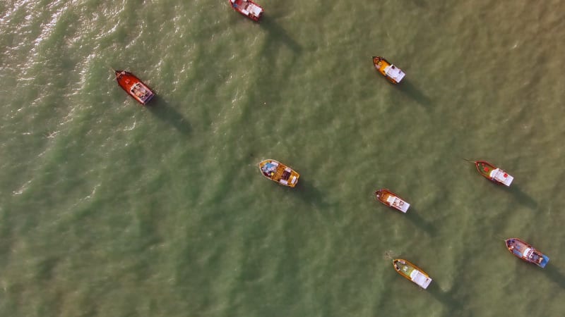 Aerial view of boats in turquoise sea.