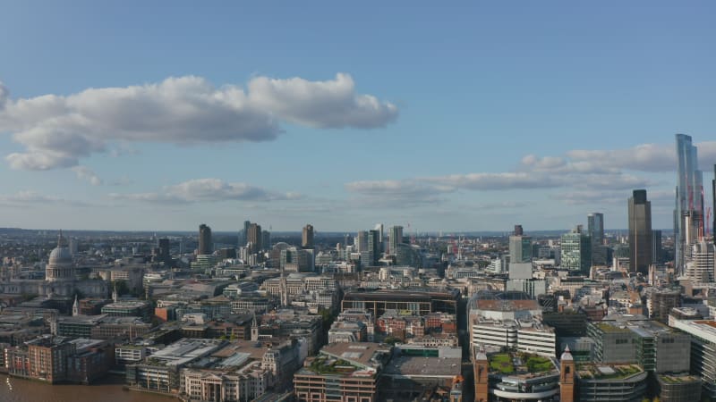 Slow forwards fly above The City of London district. Mixture of old and historic buildings with modern futuristic design tall office skyscrapers. London, UK