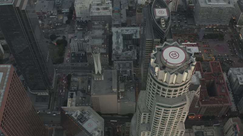 Beautiful Circling Overhead Birds View of Famous Skyscraper in Downtown Los Angeles, California in Sunset light and Car traffic