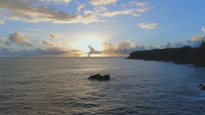 Sunrise Over A Picturesque Coastline with the Sun Rising Over the Sea