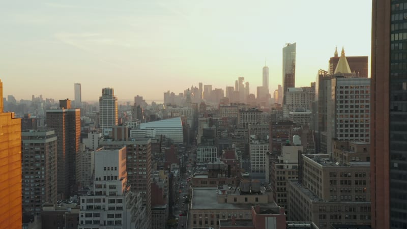 Aerial view of city development. multistorey houses and wide long streets. Downtown skyscrapers in distance. Manhattan, New York City, USA