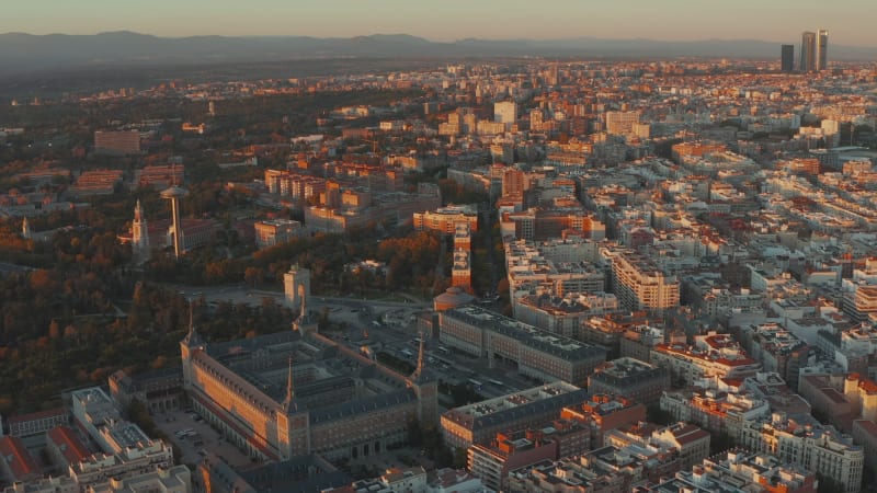 Aerial view of historic building with spires in corners. Panoramic footage of city at sunset.