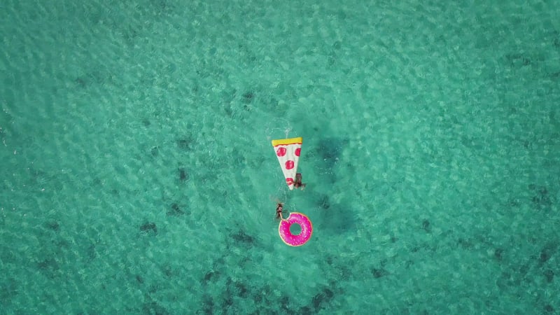 Aerial zoom view of two young girls swimming and playing.