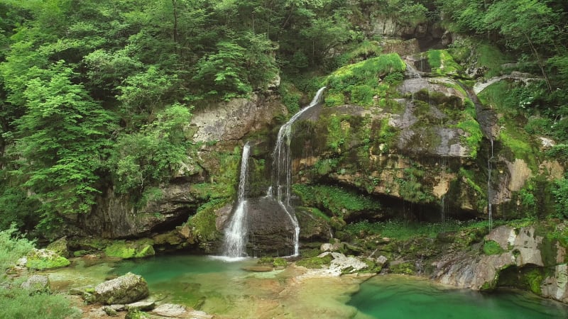 Aerial view of a small mountain waterfall with clean water.