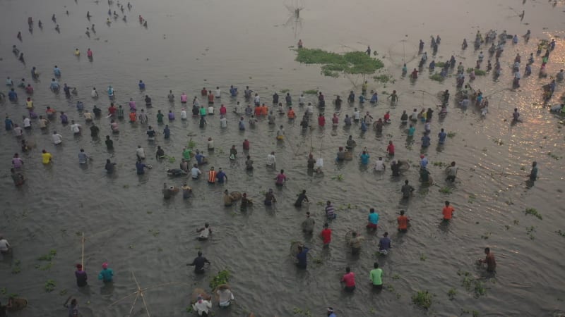 Aerial view of people working in a fishing farm with traditional fishing tool in Chatmohar, Rajshahi, Bangladesh.