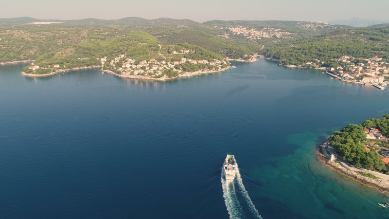 Aerial view of ferry boat approaching Sumartin port, Brač island.