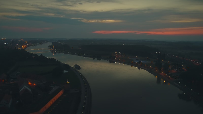 Aerial view of the Drava river and the city at sunset in Osijek.