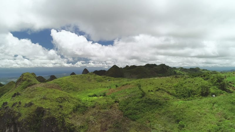 Aerial view of peak Chocolate hills and cloudy sky in Badian.