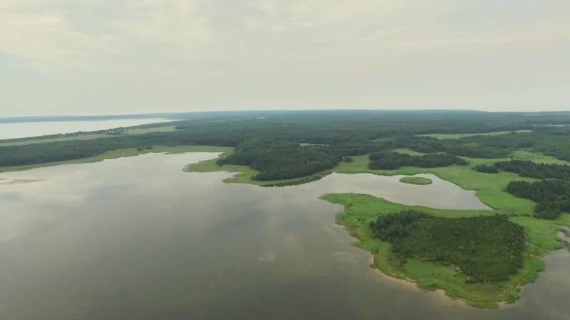 Aerial view of a small lake with stormy sky.