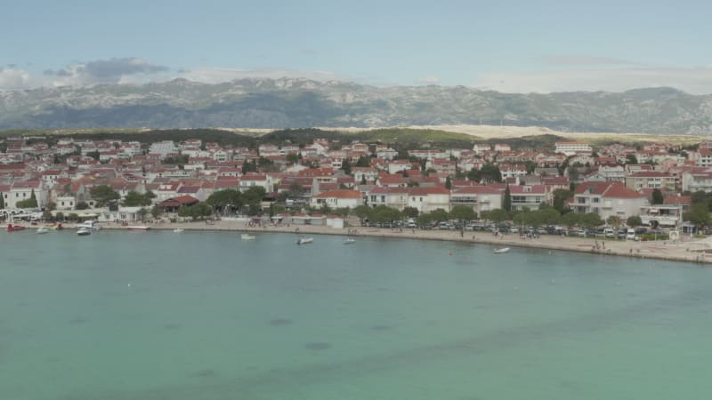 AERIAL: Flight over vacation houses villas in Novalja, Croatia Nature with blue sky and sun