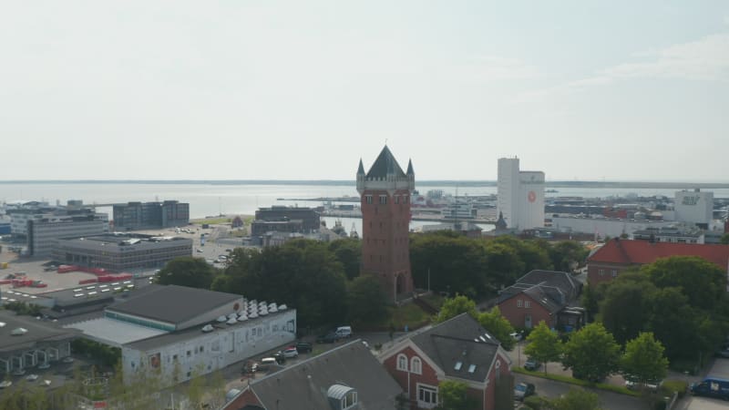 Drone slow camera rotation around the Water Tower of Esbjerg, Denmark, an iconic water tower at the top of a cliff overlooking the most important harbor of north sea