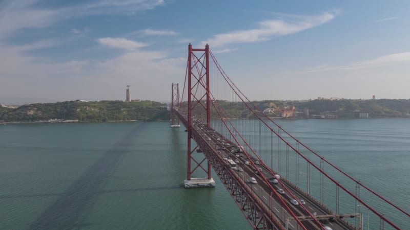 Aerial view of busy car traffic across famous red Ponte 25 de Abril bridge in Lisbon, Portugal