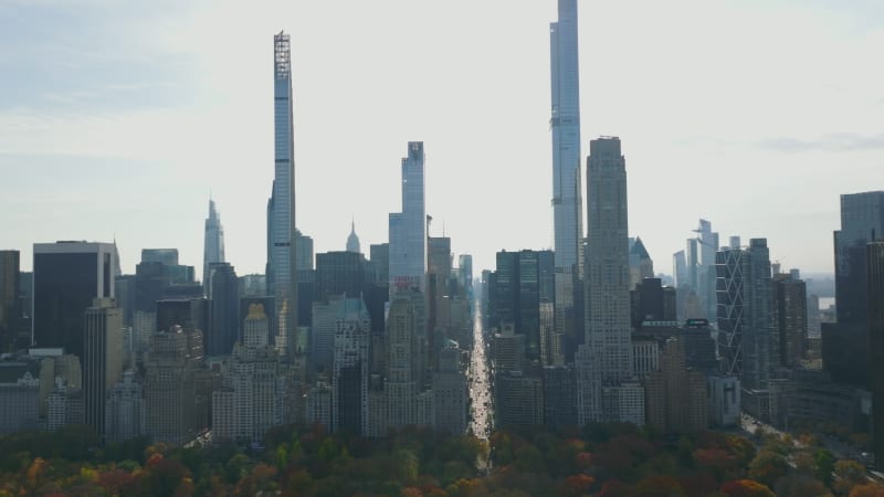 Tall modern skyscrapers and large historic buildings on south end of Central park. View against bright sky. Manhattan, New York City, USA