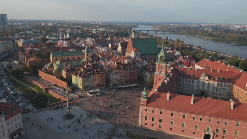 Aerial view of Royal castle complex and Castle square in old town. Tilt down focusing at house rooftops. Warsaw, Poland