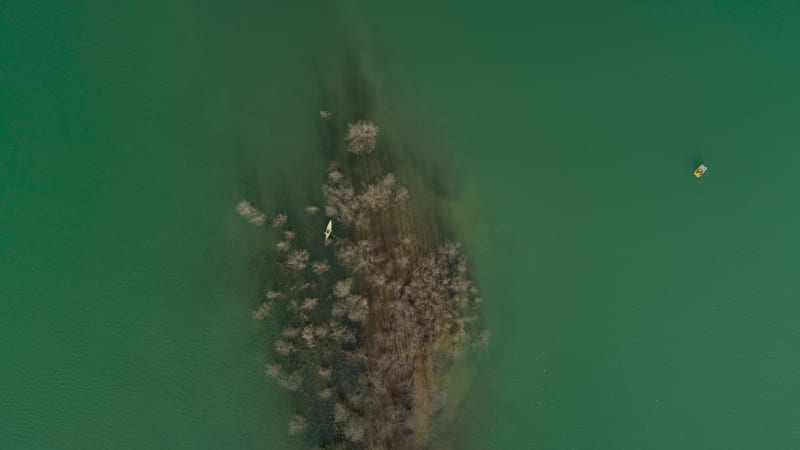 Aerial view of a person kayaking on Plastiras lake.