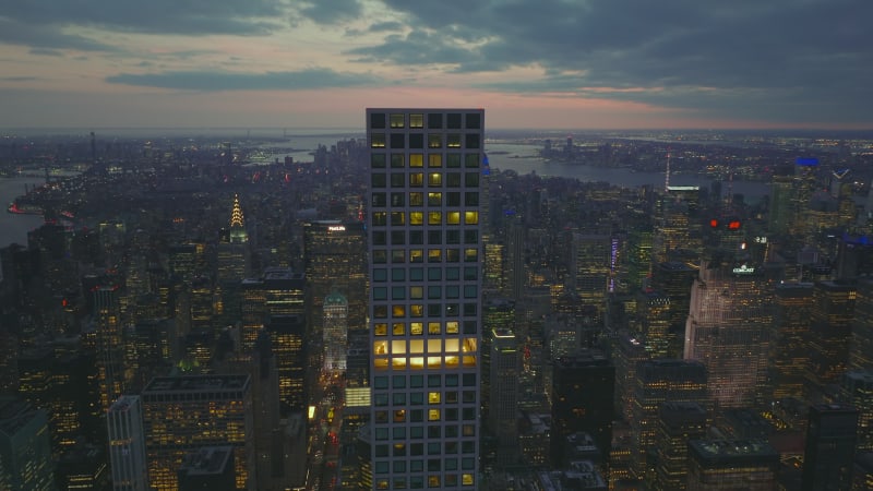 Aerial panoramic view of large city at twilight time. Tall office skyscrapers in modern city borough. Manhattan, New York City, USA