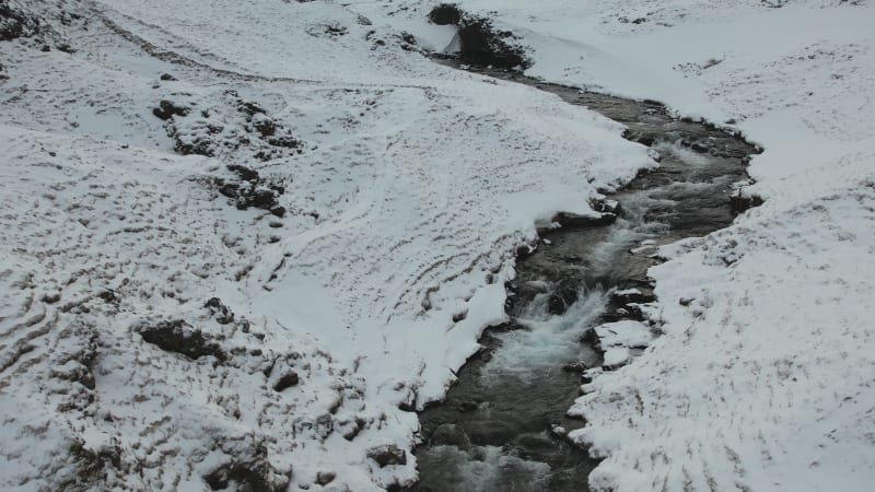 Aerial view of Stjornarfoss waterfall in wintertime in Iceland.