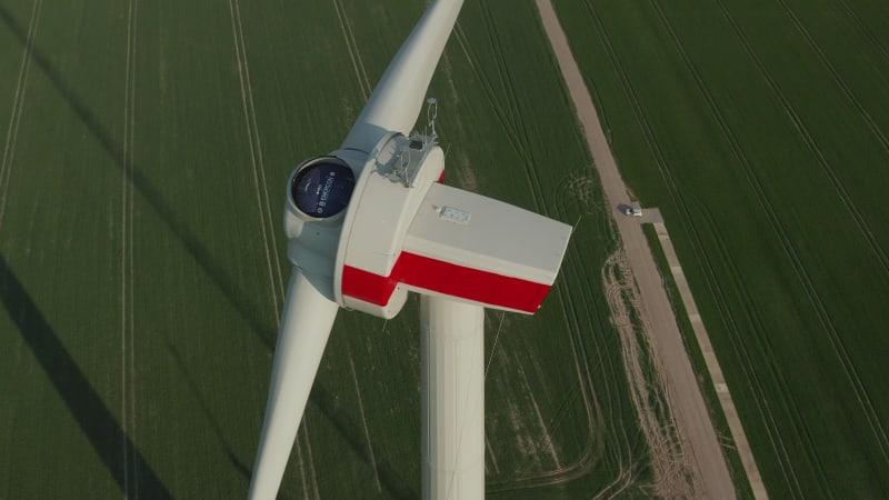 Close up of Wind Turbine under construction being built on rich green agriculture field