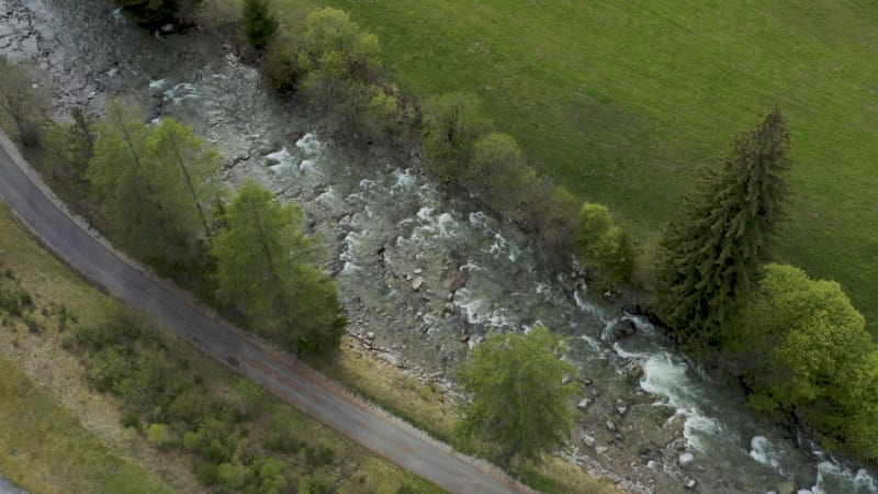 Flying above a clean mountain river flowing quickly