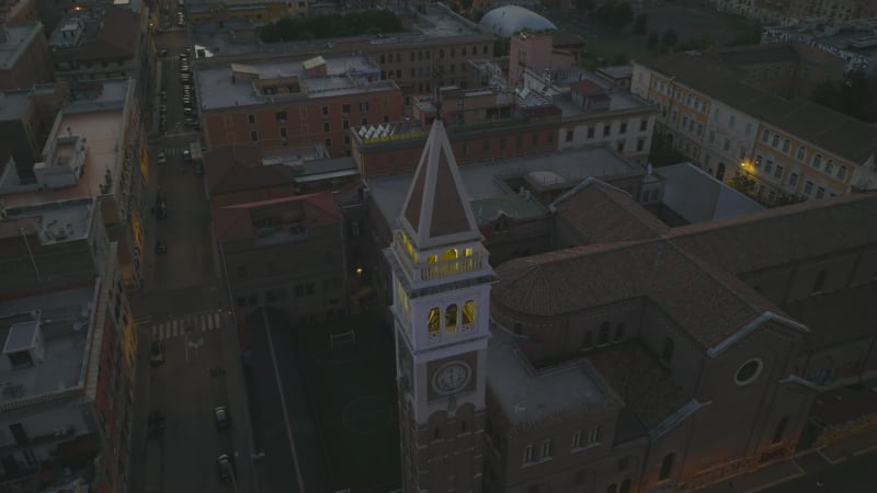 High angle view of tower and buildings. Tilt up reveal of large city and  mountain ridge on horizon. Rome, Italy