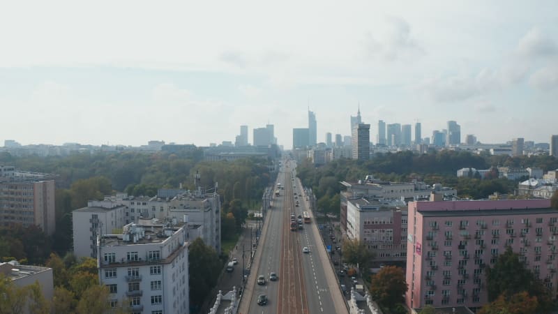 Morning low traffic on long straight and wide Jerusalem Avenue, Aleje Jerozolimskie. Skyline with modern high rise office buildings. Warsaw, Poland