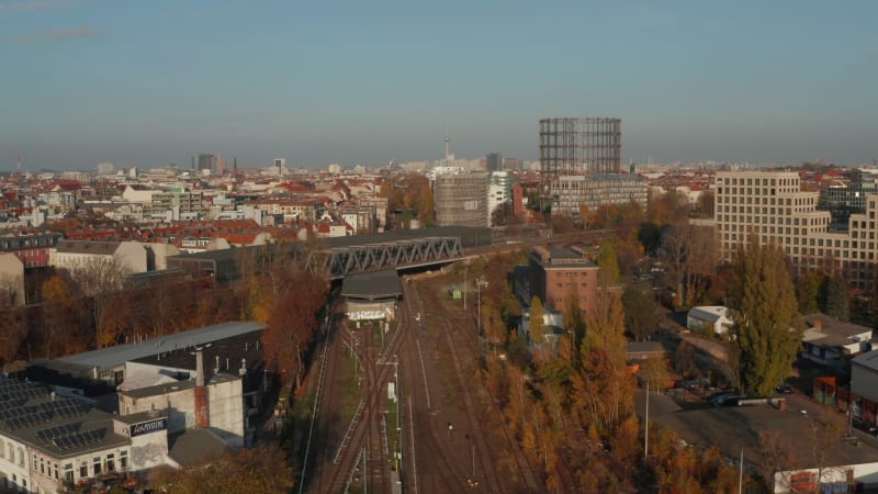 Elevated View above Train Tracks going through City with a Train in the distance, Aerial Wide View