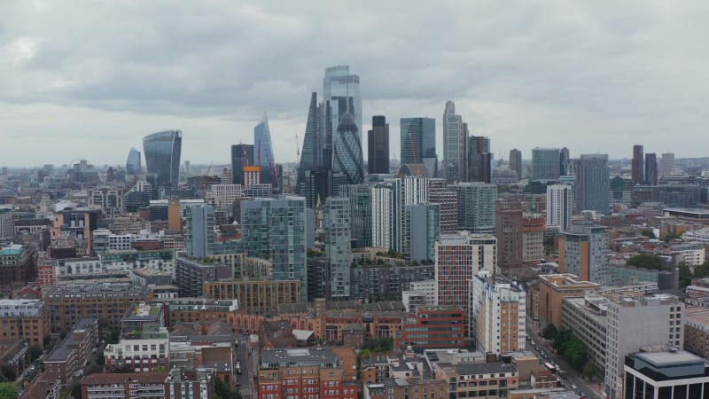 Rising shot of modern city borough. Group of business skyscrapers. Iconic Walkie Talkie,  Gherkin, Scalpel and other buildings. London, UK