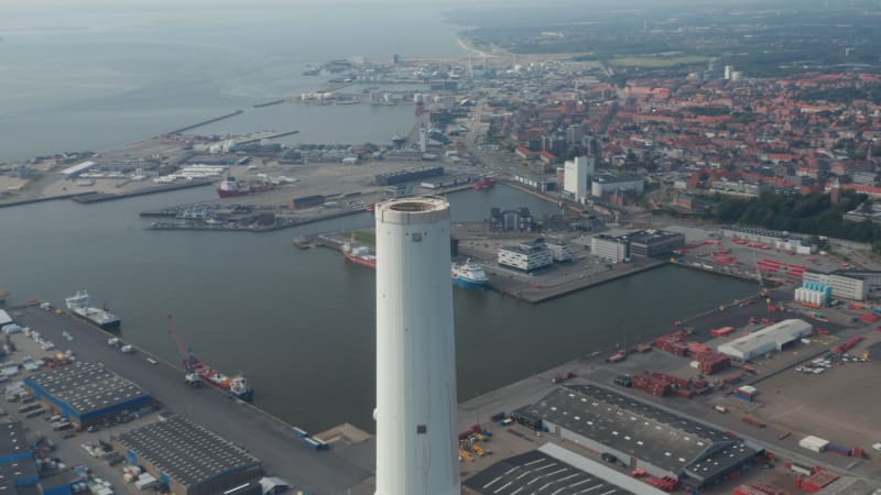 Aerial view of the chimney of the Power Station of Esbjerg, Denmark. Stunning drone view of the skyline of the city with brick wall in background