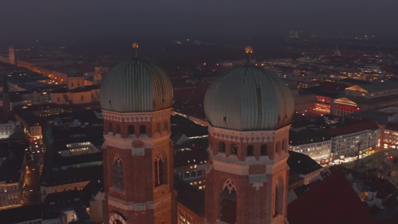 Scenic Close up Shot of Two Church Towers of Frauenkirche Church Cathedral in Munich, Germany from an Aerial Drone Perspective, Establishing Shot