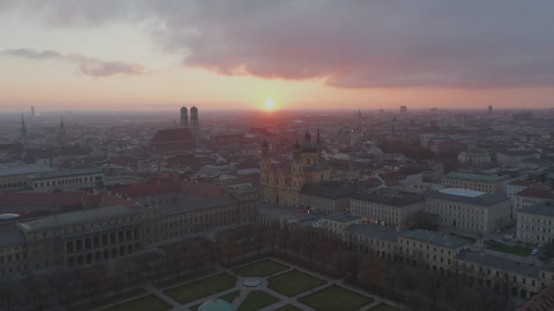 Aerial Establisher above Munich, Germany during Coronavirus Covid 19 Pandemic Lockdown, No People and No Traffic on German Streets, Aerial View at Sunset with Court Garden Public Park