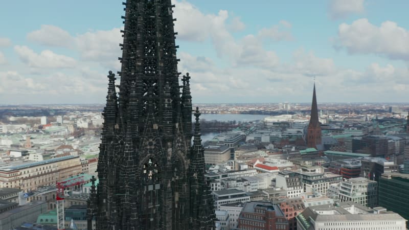 Aerial close up view of dark charred spire of St. Nikolai world war Memorial and former church ruins in Hamburg, Germany