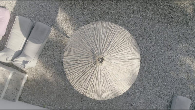 Aerial view of straw umbrella at beach in Panagopoula.