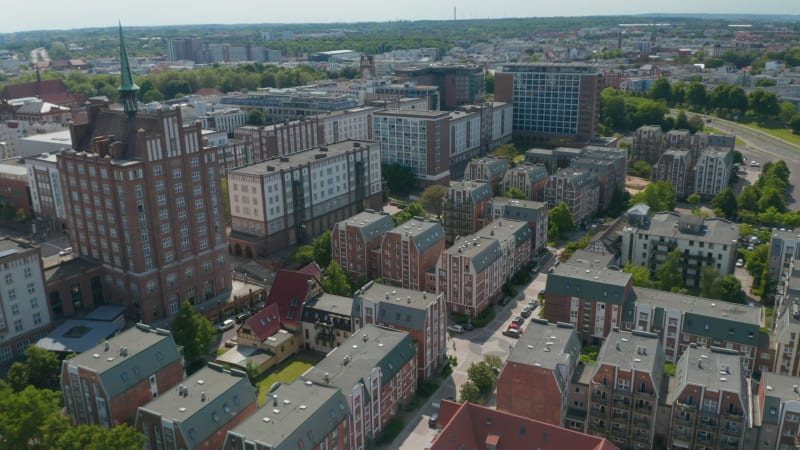 Slide and pan shot of urban neighbourhood, variety of building styles in town