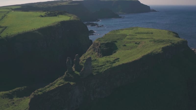 Ruins of Dunseverick Castle, Antrim Coast, Northern Ireland. Aerial drone pull away