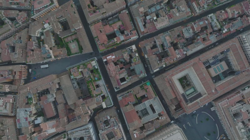 Top down panning shot of narrow streets and blocks of buildings in historic city centre at twilight. Rome, Italy