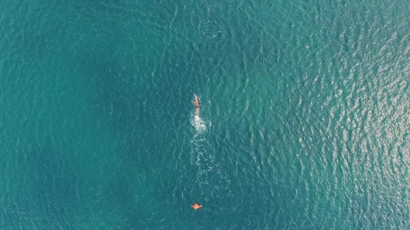 Aerial view of a group swimming at ocean water during competiti.