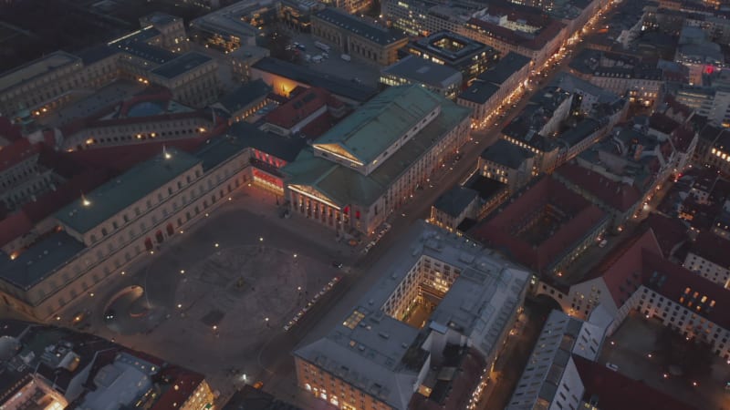 Scenic Aerial View of Bavarian State Opera Building at Night with Empty Square in front due to Coronavirus Covid 19 Pandemic, Drone Birds Eye View