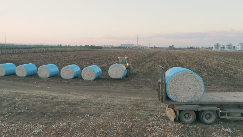 Aerial view of a tractor loading cotton bales on truck, Israel.