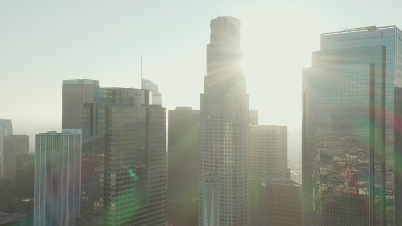 Flying towards Downtown Los Angeles, California Skyline at beautiful blue sky and sunrise