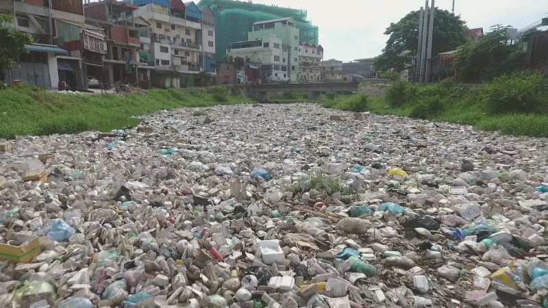 Aerial view of river with a high concentration of trash.