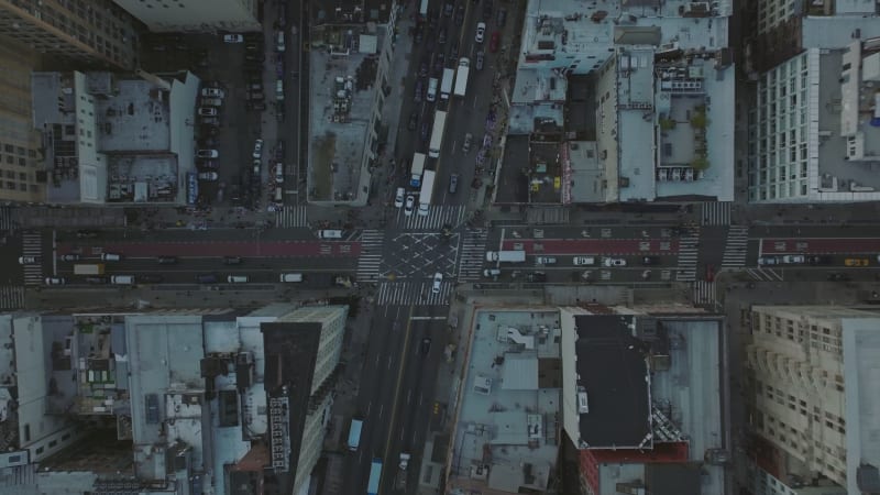 Aerial birds eye overhead top down view of traffic in streets of city. Cars get green at traffic lights on road intersection. Manhattan, New York City, USA