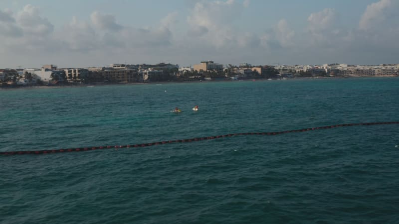 Jet ski riding on calm water surface close to Playa del Carmen, Mexico. Aerial orbit around the watercrafts