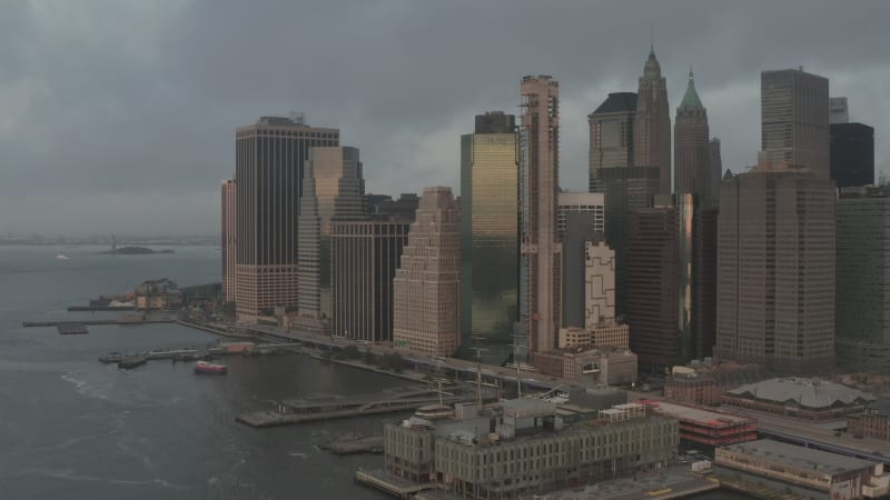 Above Spectacular Brooklyn Bridge towards foggy Manhattan New York City Skyline with Skyscrapers in Scenic Fog, Aerial Dolly in Establisher