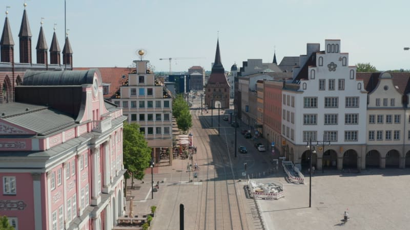 Forwards fly above street with tram tracks leading through historic city centre. Street ended with Steintor town gate