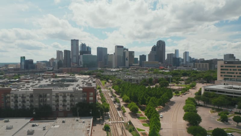 Aerial drone view of wide skyline from drone ascending above low houses in neighborhood. Dallas, Texas, US