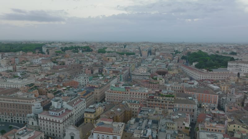 Aerial panoramic footage of buildings and streets in city centre. Large historic palaces at twilight. Rome, Italy